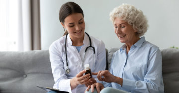 a female pharmacist with an elderly woman