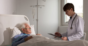 an elderly patient and a male doctor